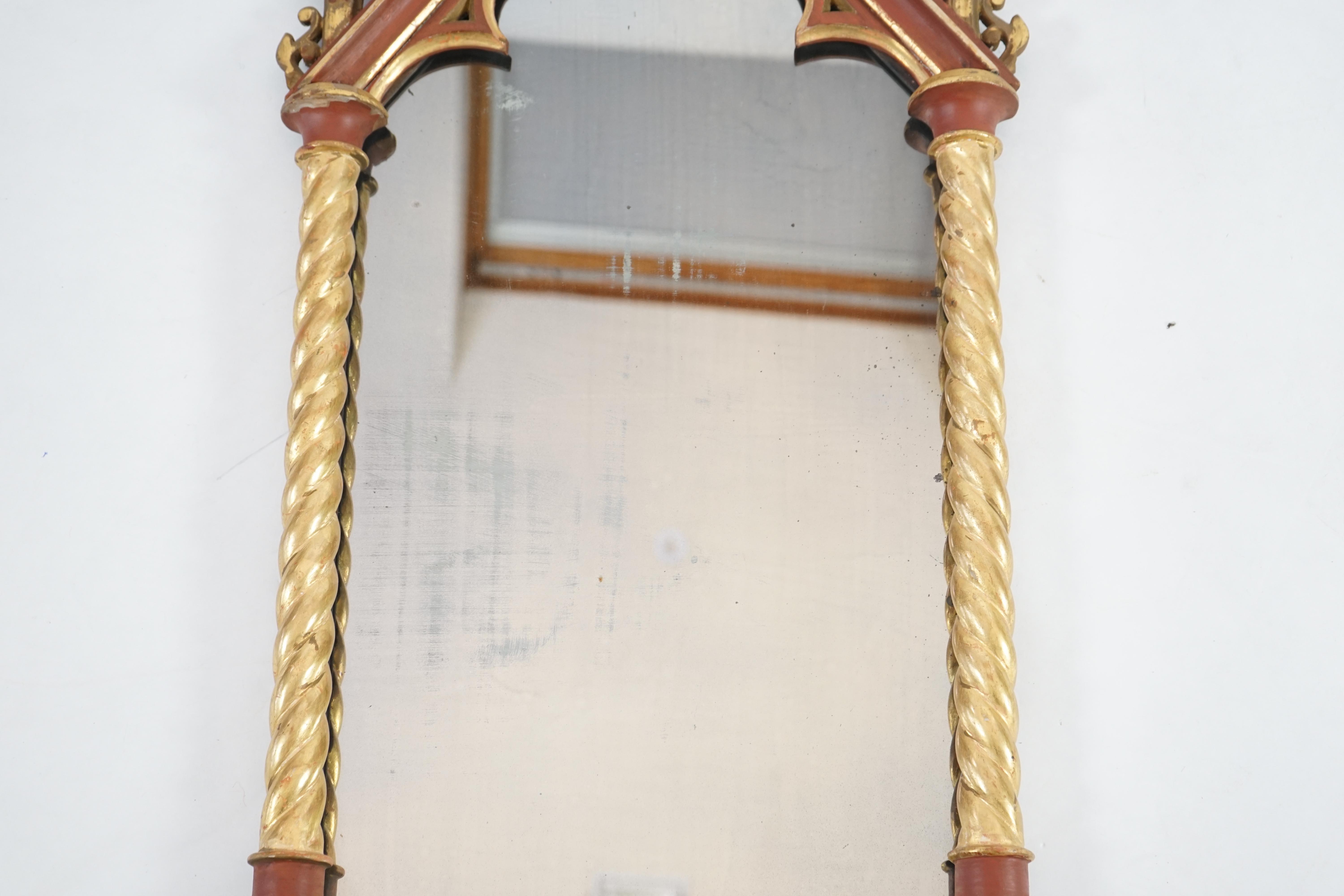 A Victorian Gothic revival painted and giltwood wall mirror